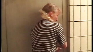 A young blonde approached by a man, hard